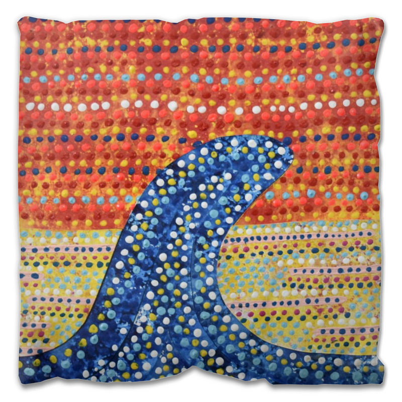 outdoor pillow with a single big blue wave against an orange sunset. 