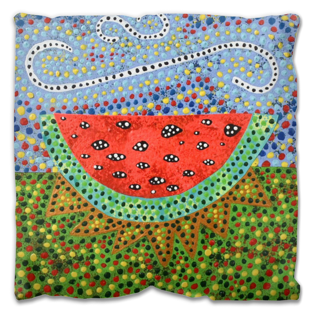 watermelon slice outdoor pillow design in reds and greens against a light blue sky.