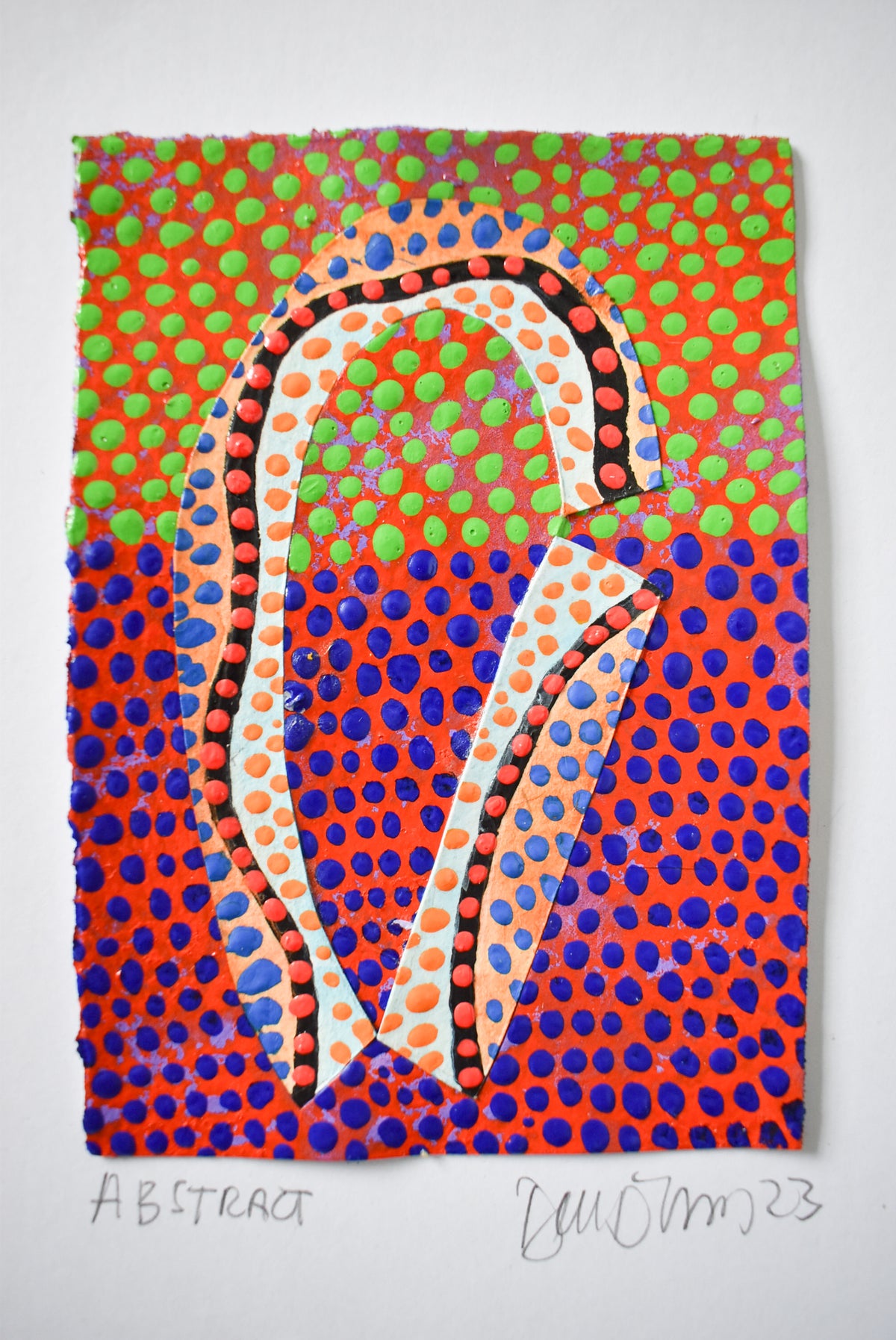 abstract arche shape in white and orange with blue and green dots on a fiery orange background.