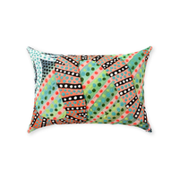 rectangular throw pillow with a dotted and striped snake against a lime green background