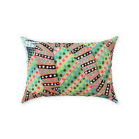 a bare striped snake slithers through lime green grass on this rectangular accent pillow.