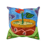 red flower throw pillow design. The flower is growing out of a red bowl with gold trim against a blue and purple background. 